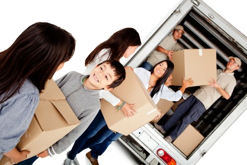 Removal van and moving team near Aldersbrook residential street