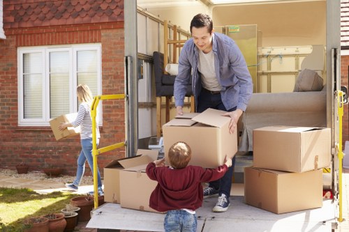 Local removal van loading household furniture in Aldersbrook