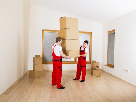 Packed moving boxes and furniture prepared for transport near Aldersbrook